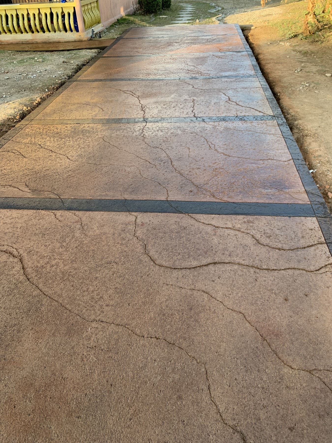 Warm stamped panels and dark borders lead back toward the veranda.