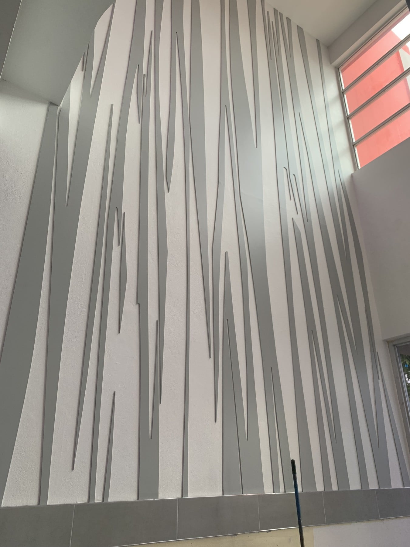 The full-height geometric relief at Fujitsu.