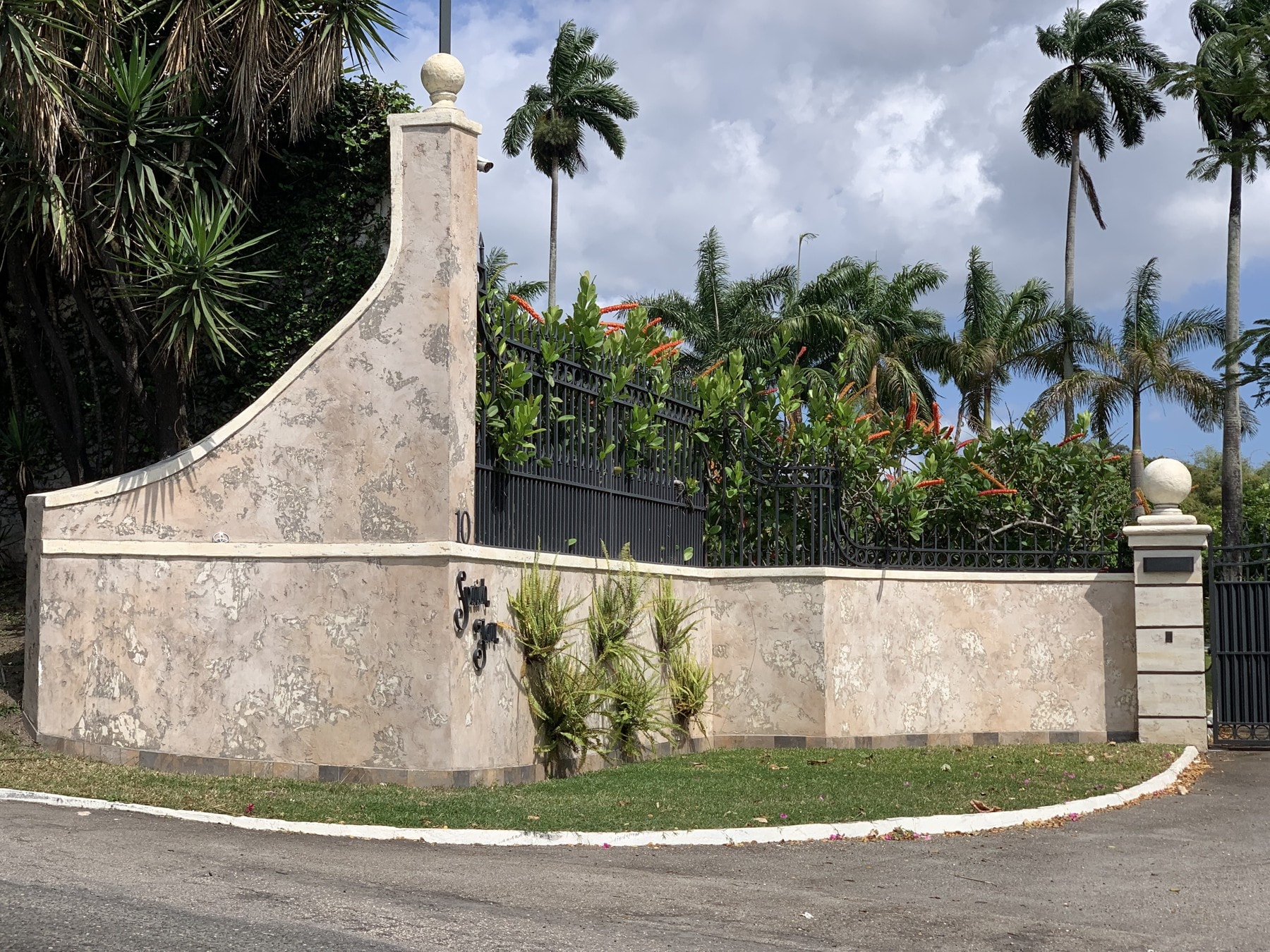 Decorative wall finish follows the curved entrance profile.