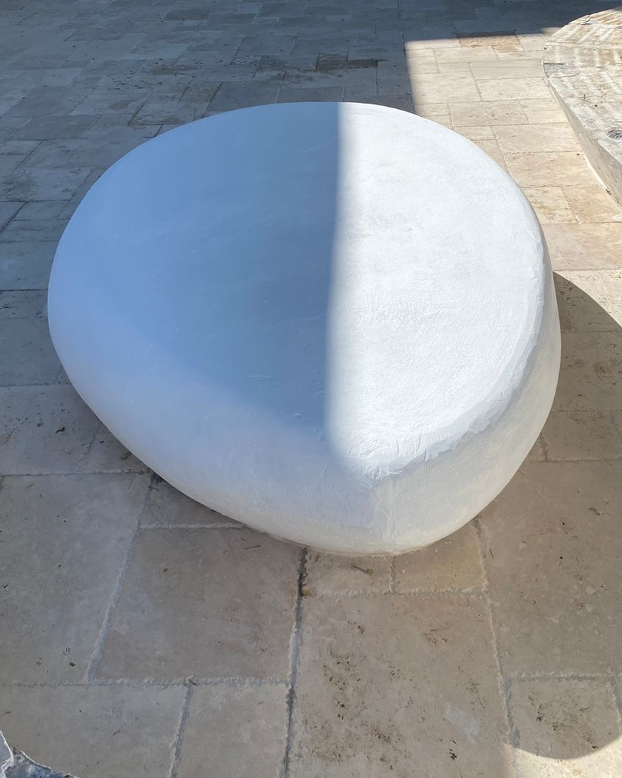 A finished white riverstone-style concrete table at the EU head office courtyard.