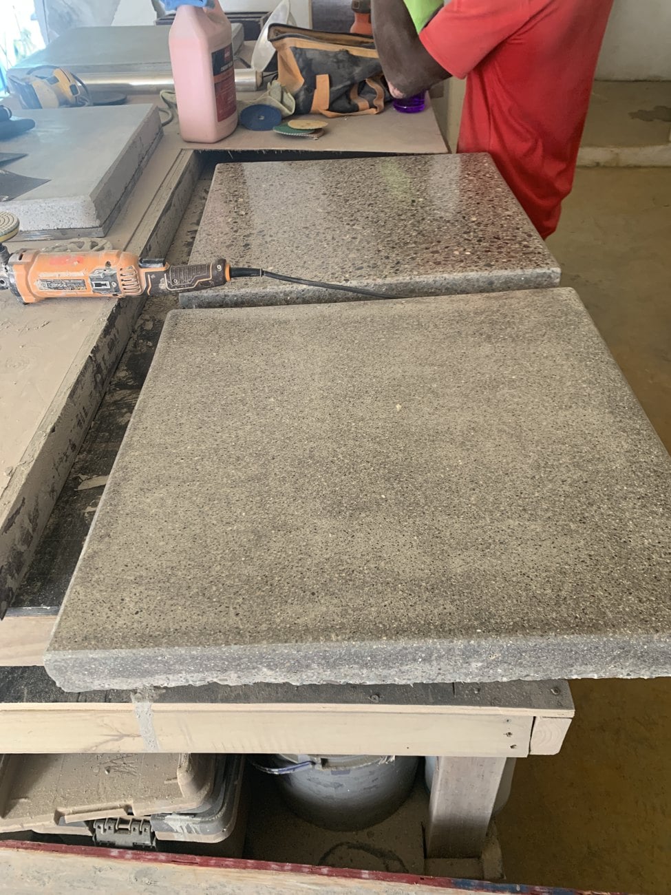 Two concrete sample boards on the ExotiCrete workshop bench showing different aggregate exposure